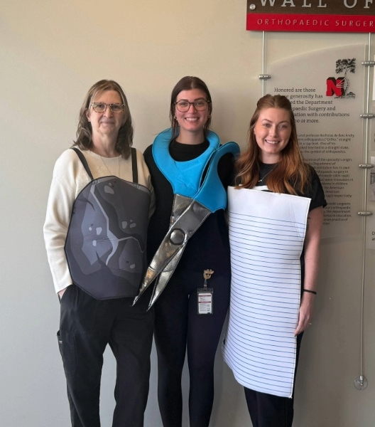 Dermatology staff in Rock Paper Scissors Halloween costumes.
