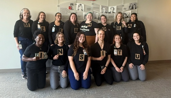 Dermatology staff in Scrabble Halloween costumes.