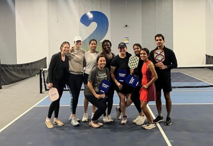 Dermatology residents pose for a picture while playing pickleball.
