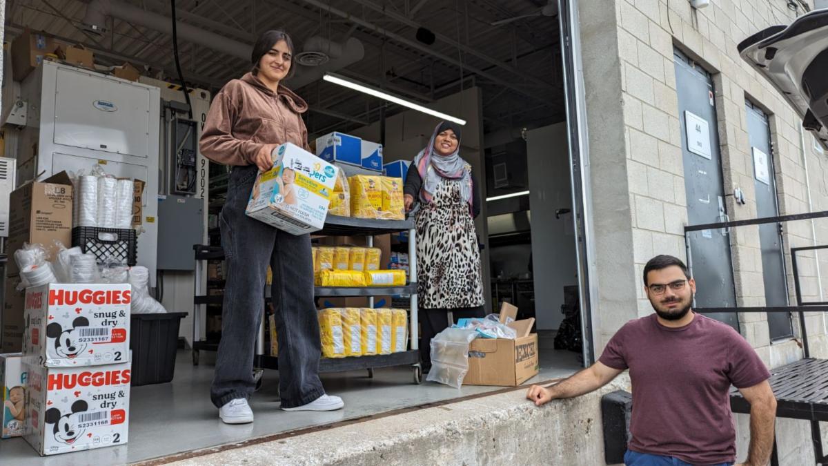 YES Group in Toronto organizing supplies to be sent to the Qajuqturvik Community Food Centre.