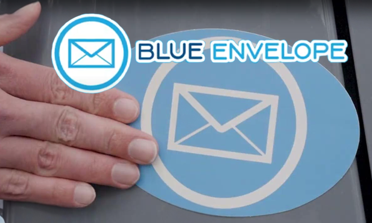 A hand is placing a blue oval sticker with a white envelope icon inside a circle below a matching Blue Envelope logo in blue and white on a gray surface