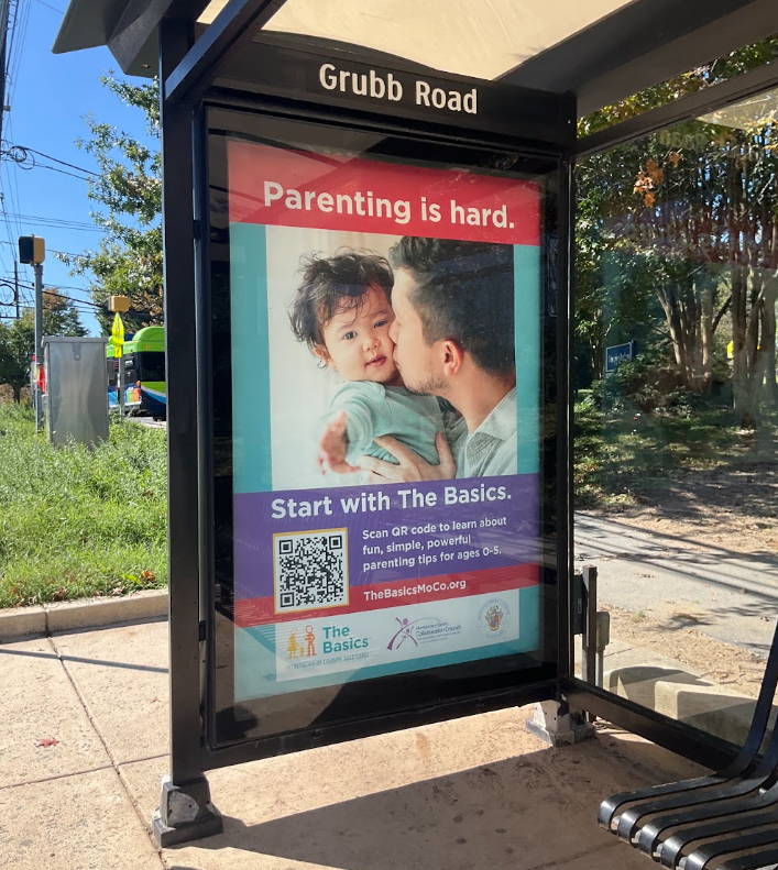 Photo of an large advertisement for The Basics at a Bus Stop in Montgomery County with the message "Parenting is Hard: Start with The Basics"