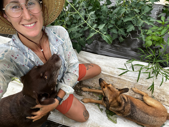 Farmer Rachel from Seven Moon Farms with two dogs.