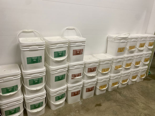 Buckets of Milkhouse yogurt ready to be distributed to schools by Peak Season, Daybreak's sister company.