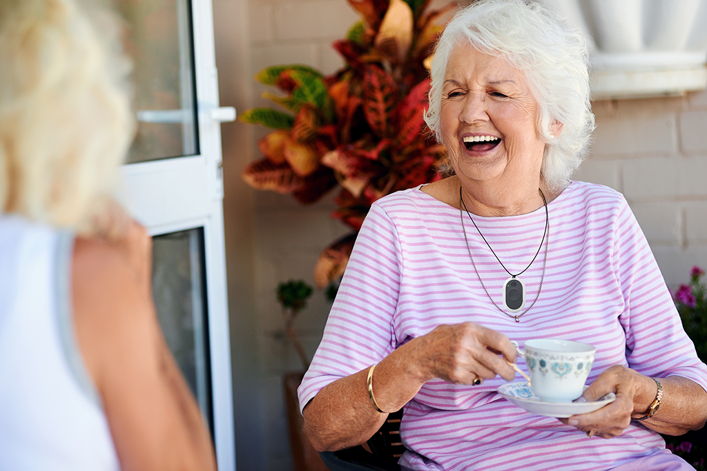 Woman in a pink shirt with a cup of coffee