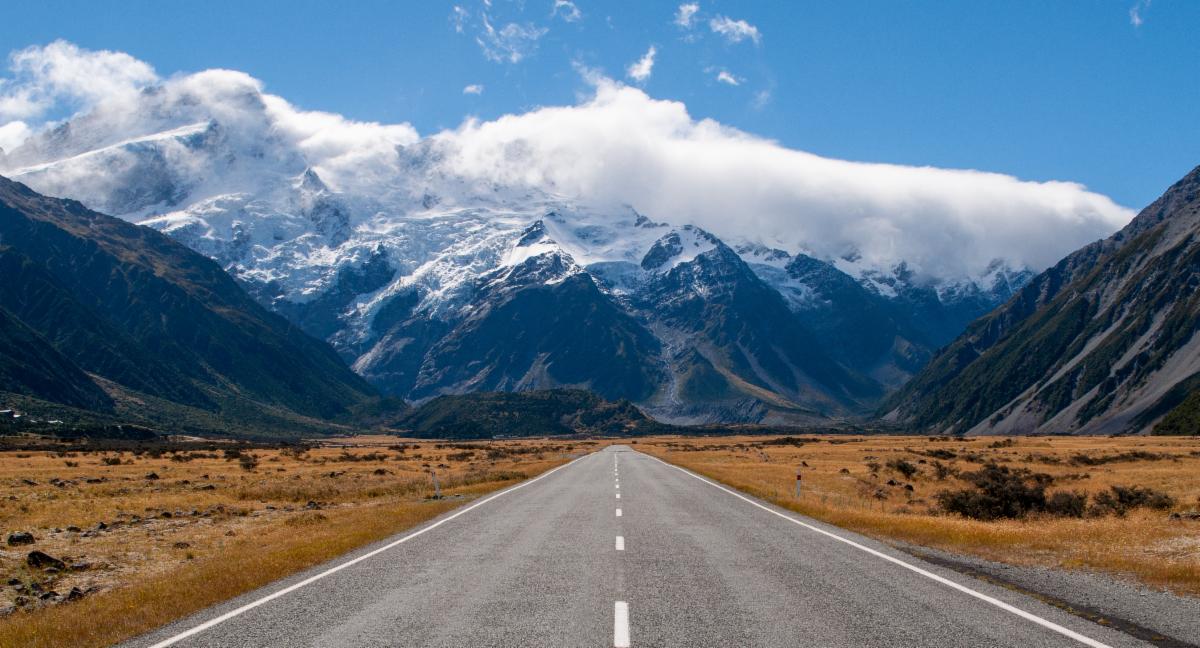 Paved road leading to mountains