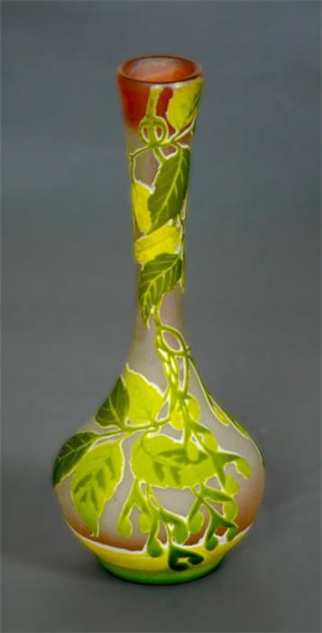 Photo of a vase with leaf decorations painted onto it