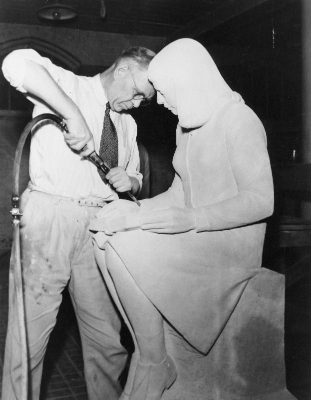 black and white photo of Christian Petersen using a tool to sculpt Library Girl