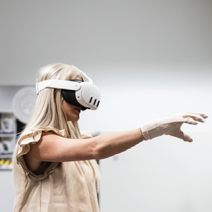 A female student wears a virtual reality headset, demonstrating how the virtual reality environment is used in Auburn classrooms