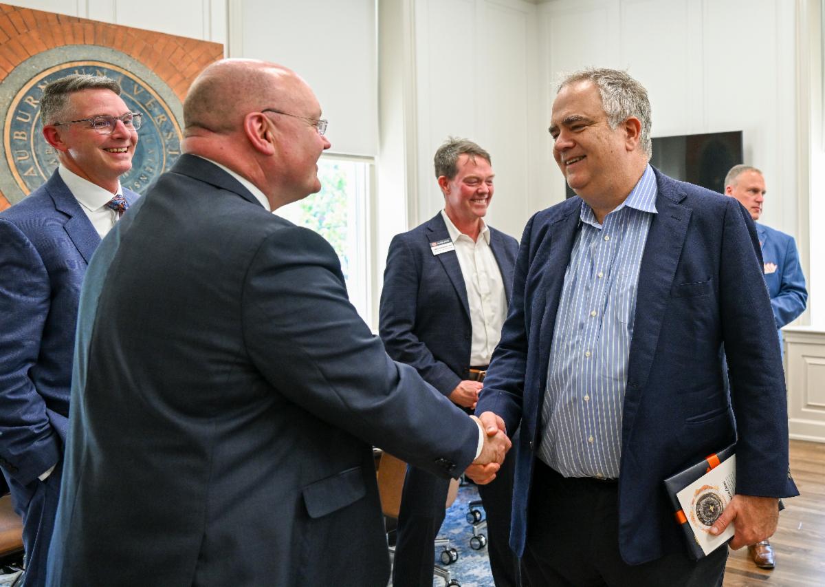 Airbus CEO Robin Hayes shaking the hand of Auburn University President Roberts with Dean Hicks and School Director Dr. Birdsong.