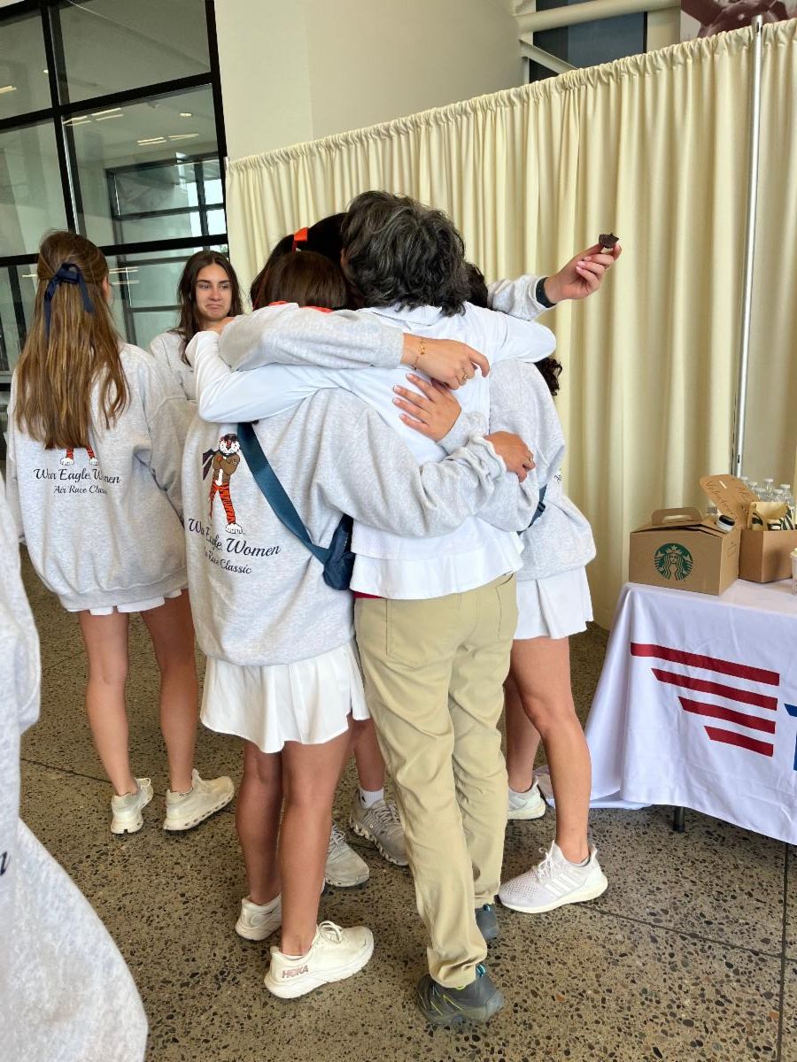The war eagle women teams are hugging after a race well done.