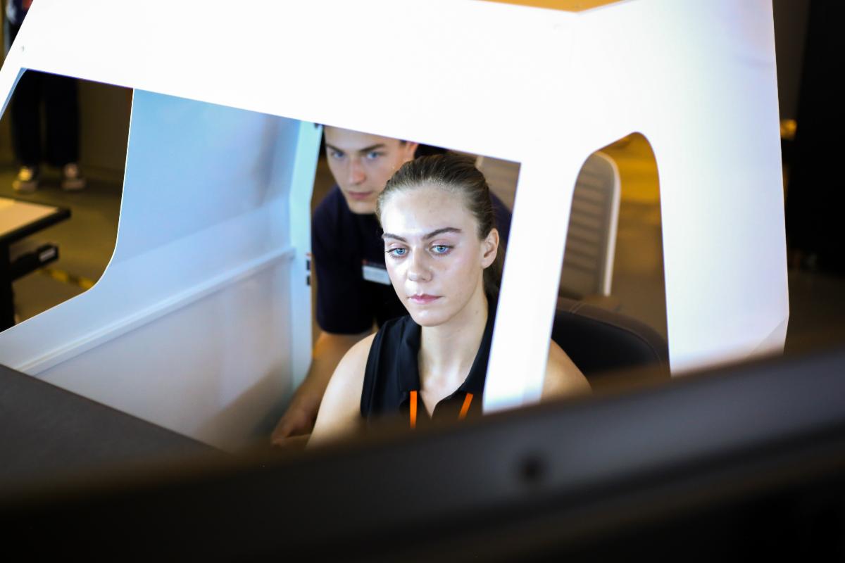 A teenage girl is flying the Auburn Plane Simulator