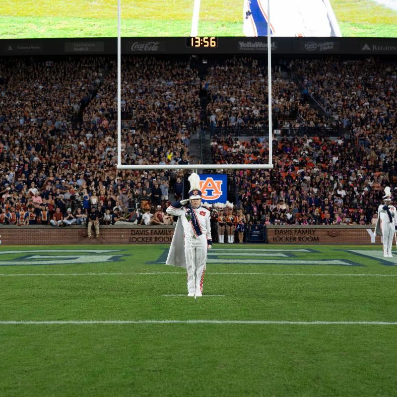 Kyla Hampson on the Auburn University Football field as a drum major