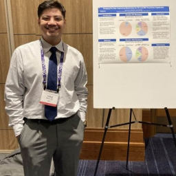 Isreal "Blad" Munoz standing in front of his TSPP poster