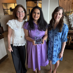 three women holding award