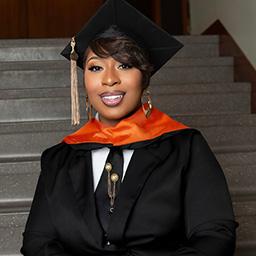 Photo of Nakita Gee with her cap and gown