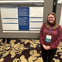 Photo of Dr. Sarah Elmer in front of a poster presentation at AAAP 2025