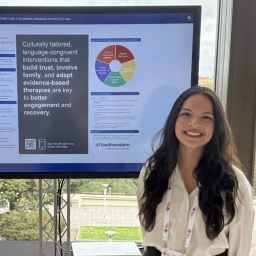 Dr Kitzia Moreno standing in front of her presentation in the Czech Republic