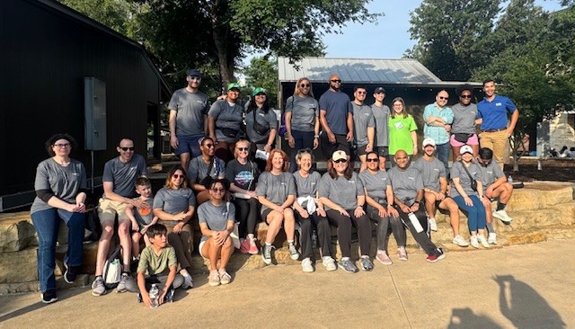 large group of people gathered together in park setting