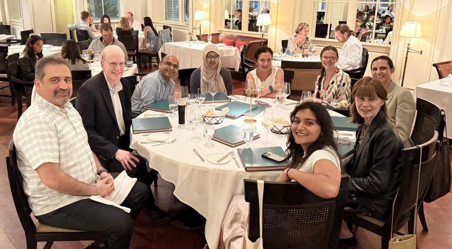 A group of UTSW doctors sit at a dinner table during the 2026 ACNP confrence.