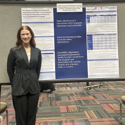 Abigail Bellatti, medical school student, in front of her poster presentation