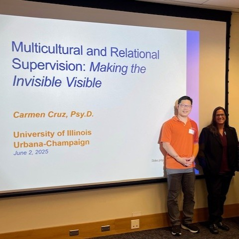 Two people in front of a presentation screen