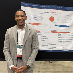 Davon Breedlove stands in front of a poster
