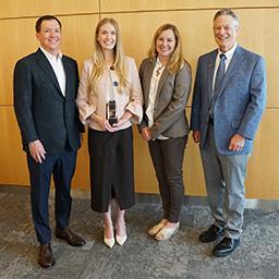Savannah Dieste accepts the Ida M. Green Award surrounded by individuals from UT Southwestern
