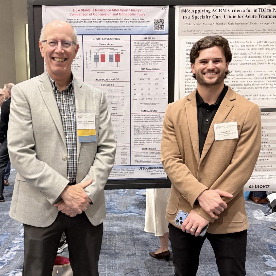 Dr. Munro Cullum and Logan Shurtz pose in front of Shurtz's poster