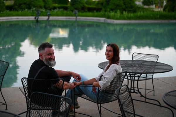 Photo of two guests enjoy a sunset by the Reflecting Pool at Cranbrook Institute of Science. Photo by Eric Franchy.