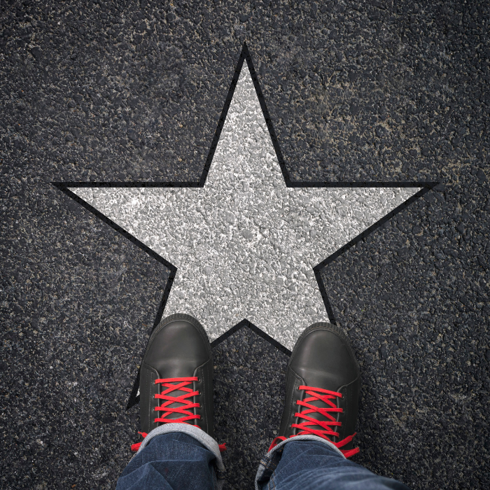 photo of star on sidewalk with feet in hiking boots 