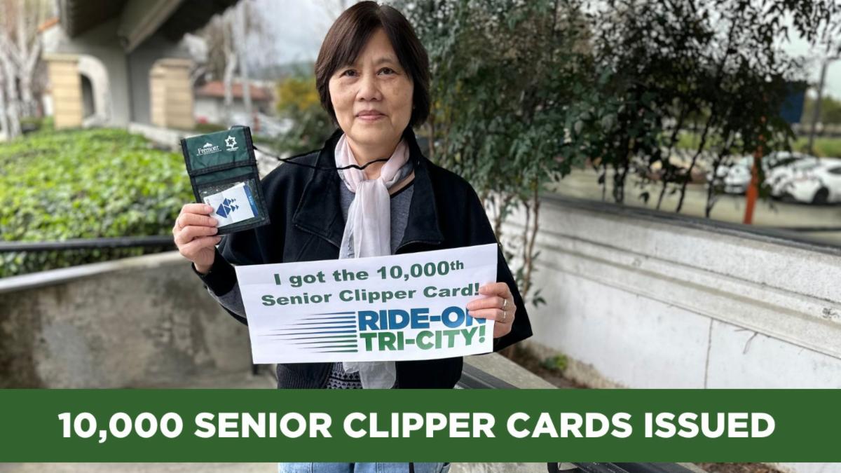 10000 senior clipper cards issued woman holding sign that says i got the 10000th senior clipper card