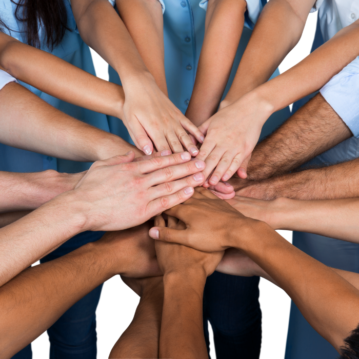 hands from several people stacked 