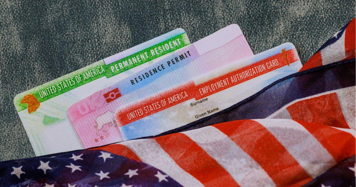 US immigration documents on a table with the corner of an American Flag