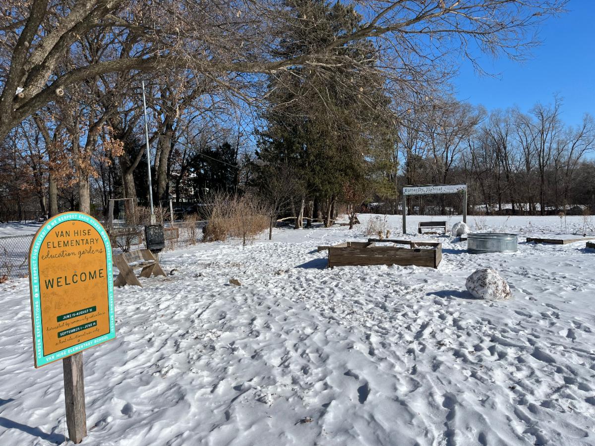 a snow packed ground covers the playground side garden with the VHE garden sign in the corner