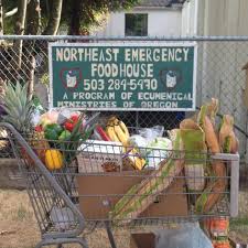 A grocery cart sits in front of a sign promoting the Northeast Portland Emergency Food Program