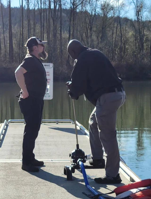 Two MCEM employees use the DIVVY Water pump.