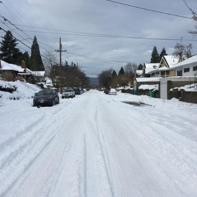 Street filled with snow lightly plowed