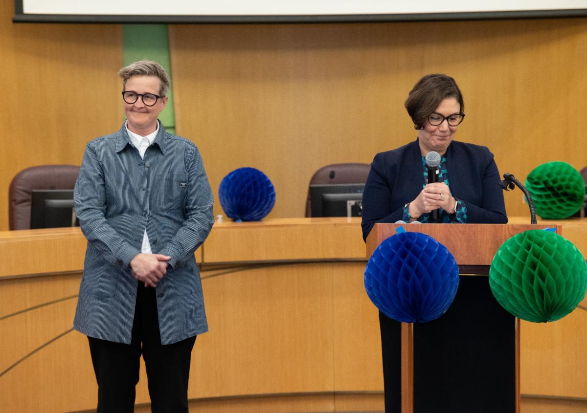 Kirsten "Kupp" Kuppenbender is presented the Superior Public Service Award by County Chair Jessica Vega Pederson.