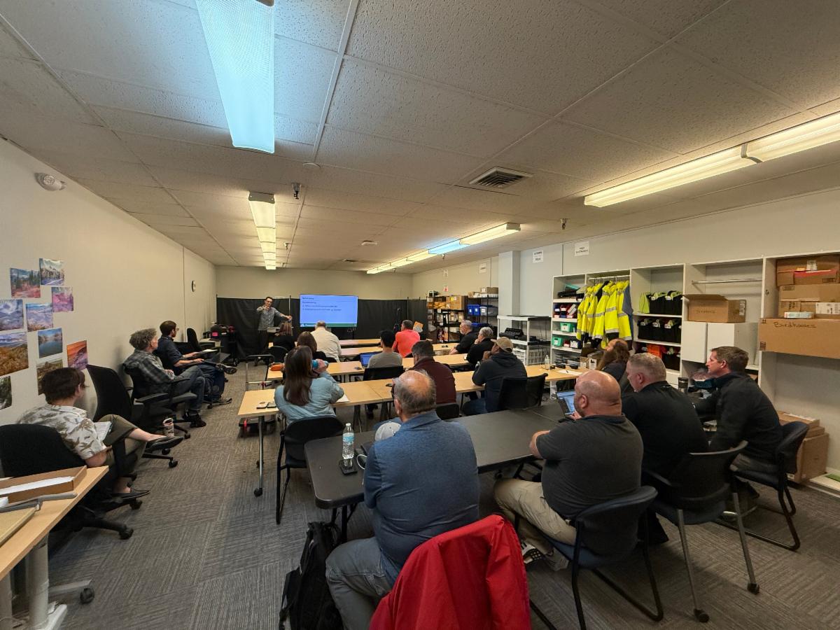 Gabriel, an MCEM employee, speaks to a group of radio users.