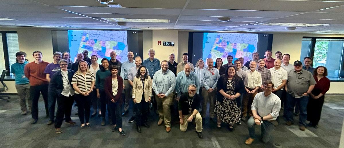 NASA Team members and regional partners stand together, smiling.