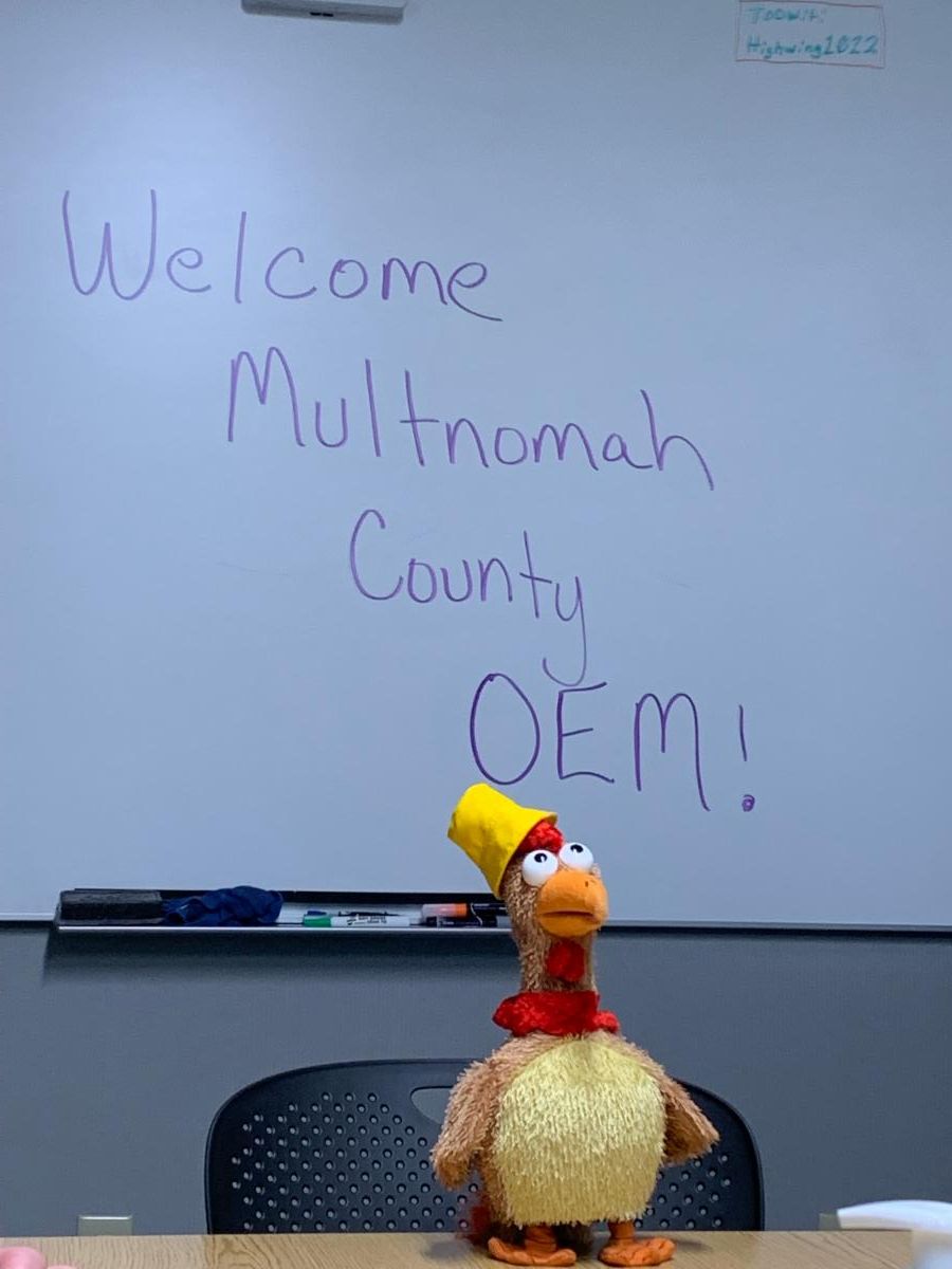 NWS mascot Larry Chicken in front of a white board that says Welcome Multnomah County OEM!