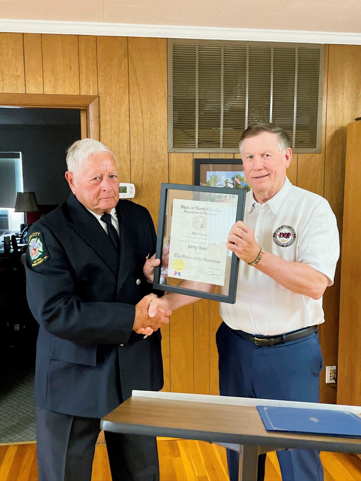 Commissioner Causey presenting guardian award to Jerry Ward