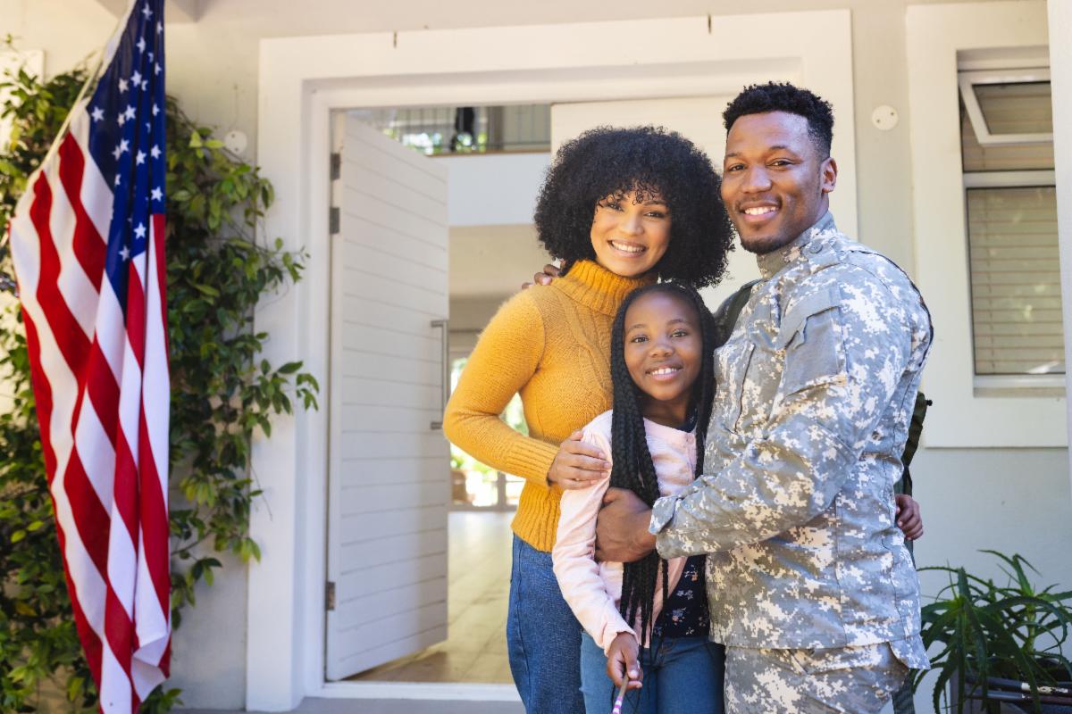 Military family in front of their house
