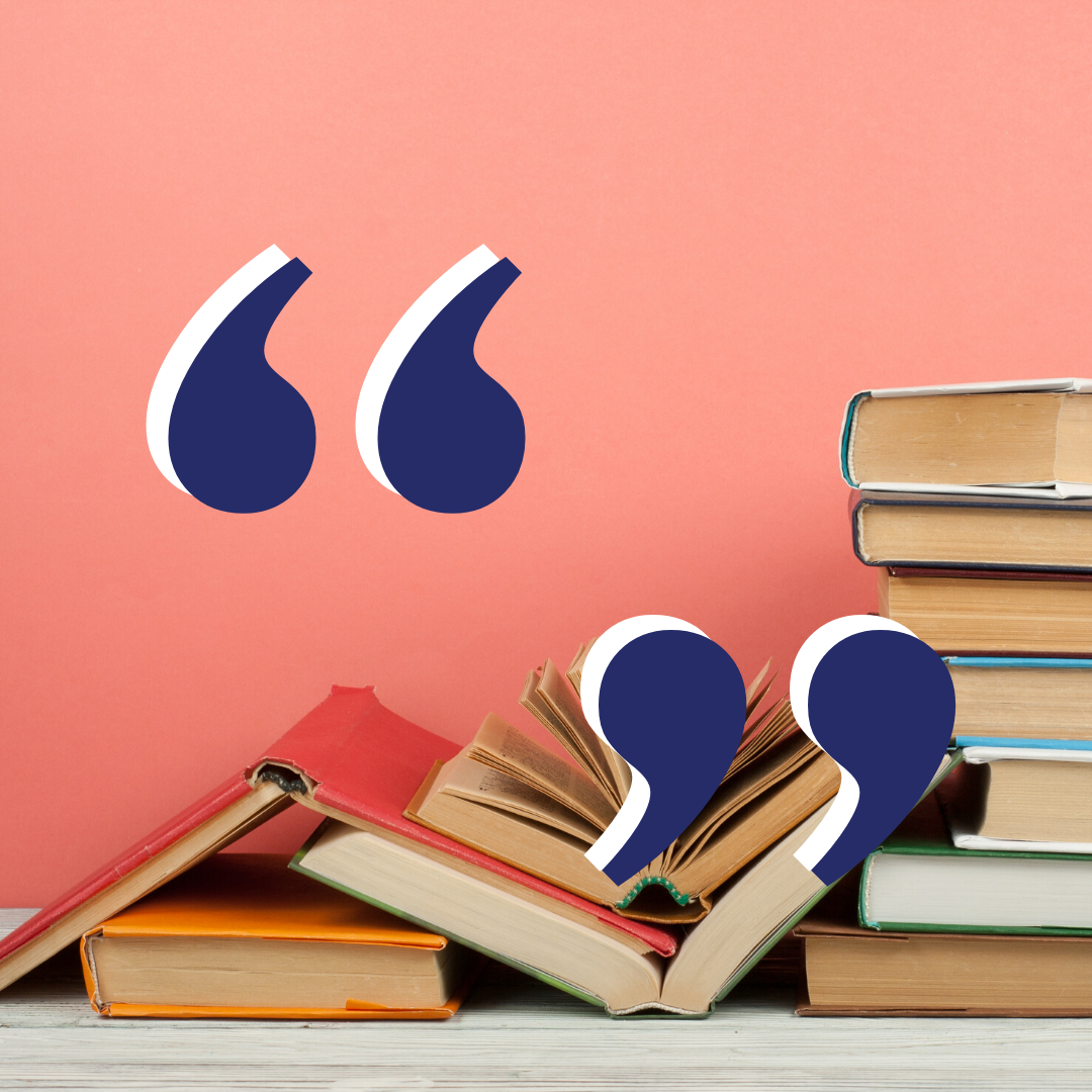 Quotation marks over stacks of books in front of a pink wall.