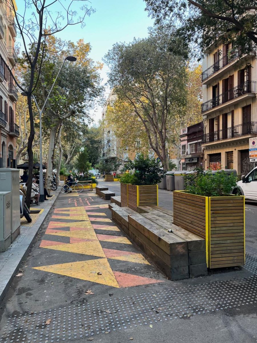 Seating and planters placed in the street.