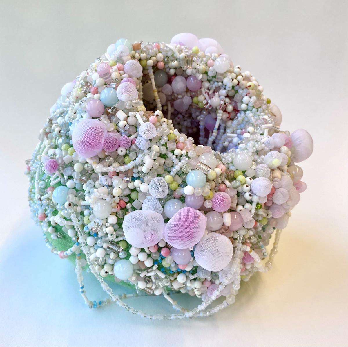Glorification of Motherhood an art work by Shari Dierkes a vase like piece made from wool and polyester covered in beads