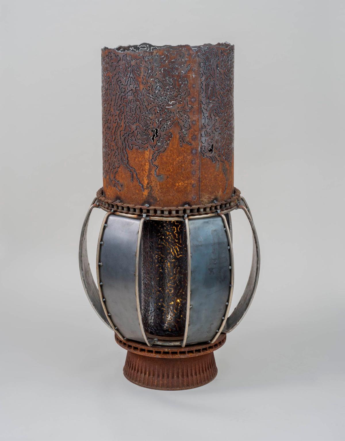 Gatekeeper III an art work by Colleen Zufelt that resembles a lantern made from steel and recycled parts welded together