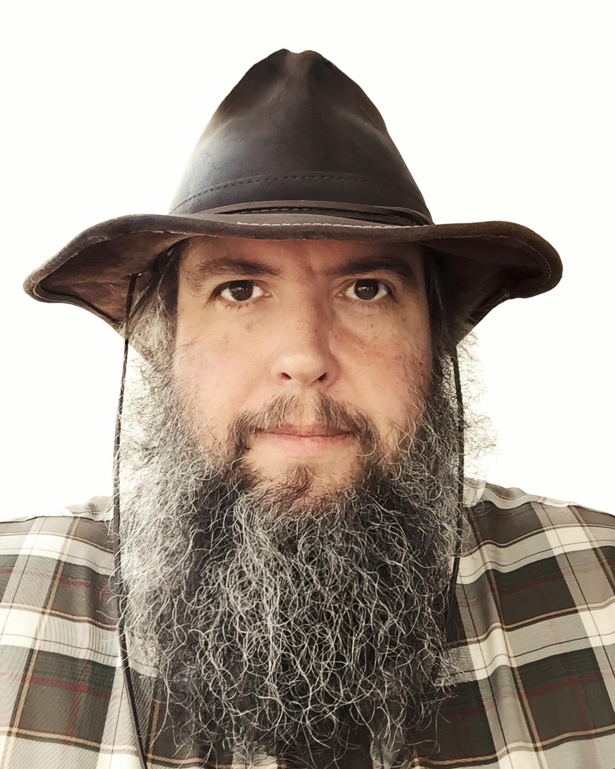 Headshot of Eric Zippe looking straight at the camera and wearing a hat