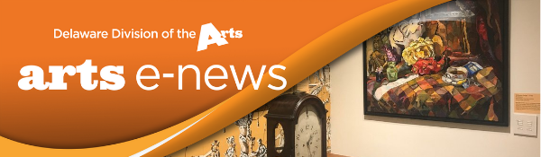 Delaware Division of the Arts arts enews on an orange banner over an image of two walls meeting in a corner in the Biggs Museum One wall has a painting hanging on it and the other wall has decorative yellow wallpaper with a desk clock in front of it